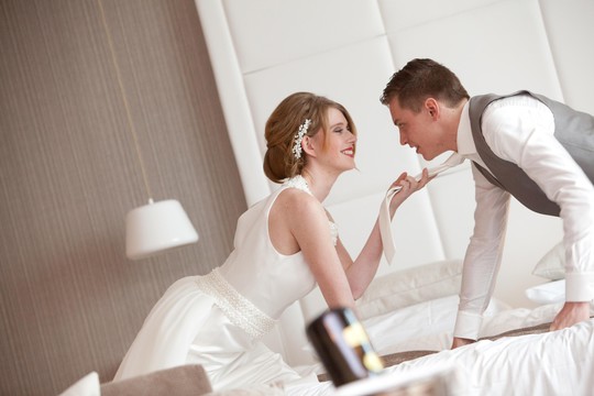 Bride and groom on bed